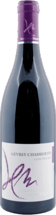 Eine Flasche Heresztyn Mazzini 2020 Gevrey Chambertin Vielles Vignes Cuvée Les Jouises, mit violetten und weißen Akzenten und einer stilisierten Unterschrift auf dem Etikett. Der lilafarbene Verschluss hat einen passenden Text.