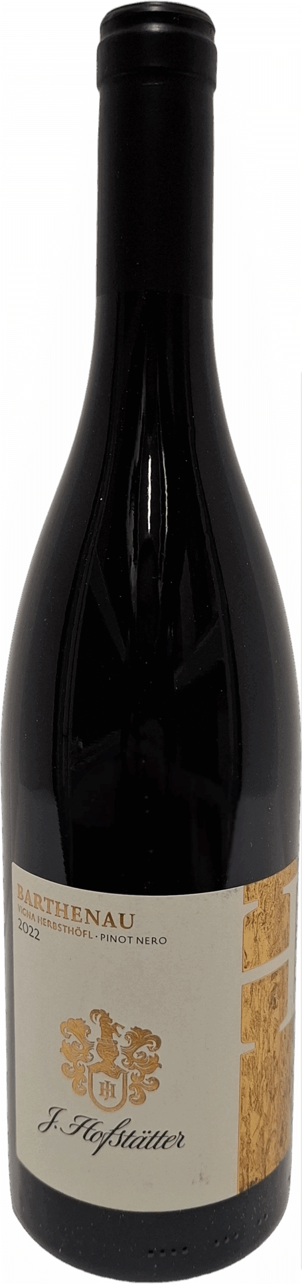 Eine Weinflasche aus dunklem Glas mit der Aufschrift "J.Hofstätter | Barthenau Vigna Herbsthöfl Pinot Nero Südtirol" und einem Etikett in Gold und Creme.