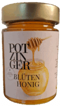 Ein 250g-Glas Blütenhonig mit einem goldenen Deckel. Das Etikett zeigt einen Honiglöffel, der Honig in ein Glas tropft, dekorativen deutschen Text und enthält goldgelben Honig.